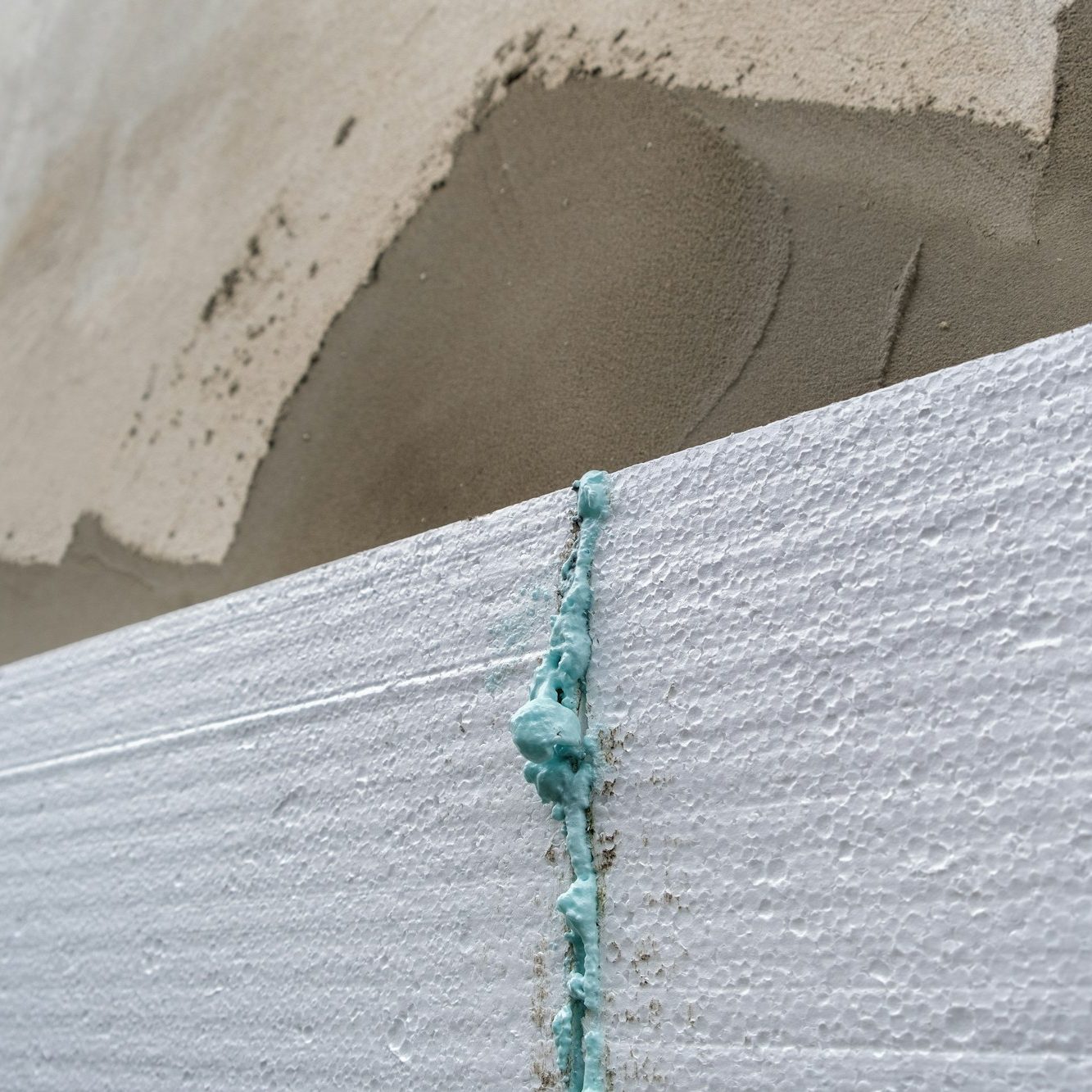 Installation of styrofoam insulation sheets on house facade wall for thermal protection